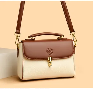 Close-up of leather doctor bag with embossed F logo and gold-tone metal clasp lock