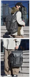 Detail of vintage dark grey PU leather backpack with buckle straps in urban street setting