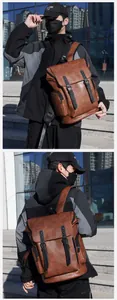 Detail of vintage brown PU leather backpack featuring dual buckles and side zipper pockets