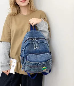 Détails du sac à dos en denim délavé bleu avec fermetures éclair et poignée bleue