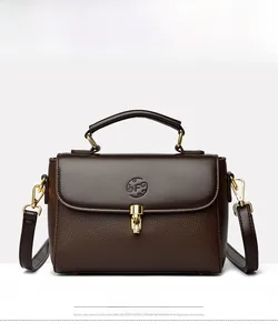 Front view of brown leather doctor bag with gold metal lock and embossed logo detail