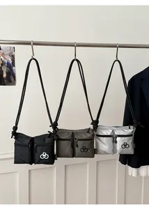 Detail of waterproof nylon tote bags in black and silver with rope shoulder straps