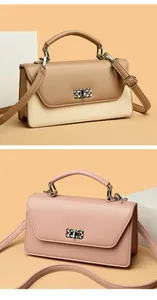 Close-up of geometric rhinestone twist lock and matte PU leather on baguette bags