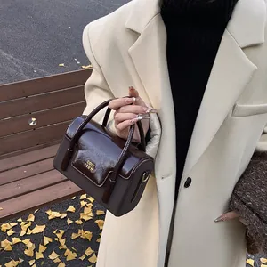 Vintage dark brown square shoulder bag with gold hardware and two-tone stitching