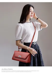 Detail of retro leather crossbody bag with marble buckle on white puff sleeve outfit
