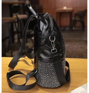 Détail du sac à dos en similicuir noir avec rivets argentés et fermeture éclair en métal