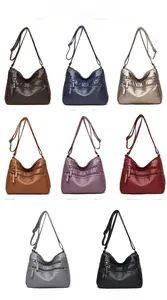 Detail view of eight colorful washed leather crossbody bags with multi-zipper compartments