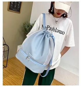 Detail view of blue drawstring fitness bag with separate bottom shoe compartment