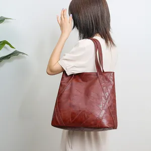 Retro brown oversized tote bag worn by model showing vintage texture and stitching