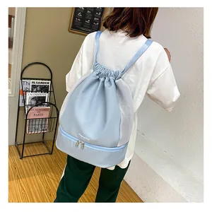 Light blue drawstring gym bag featuring a separate bottom shoe compartment and mesh detail