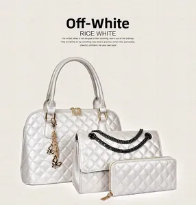 Detailed view of rice white 3-piece bag set with classic quilted texture and gold hardware