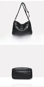 Detail view of the black washed leather shoulder bag showing the back pocket and flat bottom