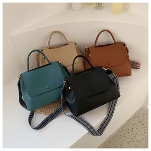 Detail showing four minimalist leather handbags with decorative ethnic woven shoulder straps