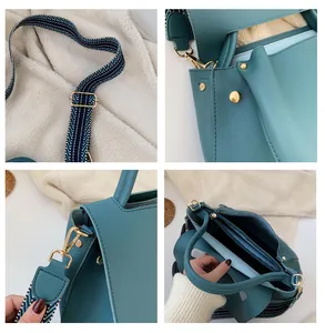 Detail view of teal leather handbag with gold hardware and wide woven strap
