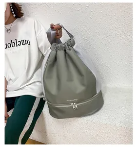 Detail of gray-green waterproof gym bag showing dry-wet separation and bottom shoe compartment