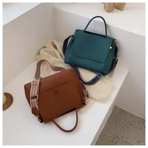 Detail of minimalist leather crossbody bags featuring stylish geometric patterned wide straps