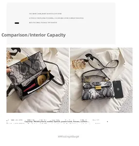 Detail showing internal capacity of snakeskin print crossbody bag with golden hardware