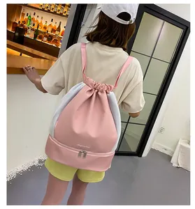 Detail of pink sports drawstring backpack featuring a separate bottom shoe compartment