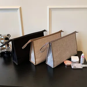 Macro shot of minimalist canvas document bags in khaki and black with sturdy handles