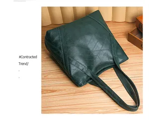 Detail of dark green tote bag with irregular stitched texture on a wooden surface
