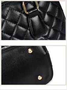 Detail of black quilted leather handbag showing golden hardware and protective bottom studs