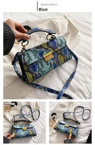 Detail of blue faux snake pattern bag with golden lock and round top handle