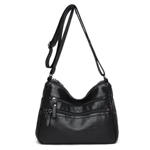 Classic black leather crossbody bag with multiple zip pockets and adjustable strap