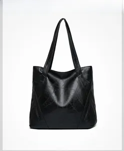 Front view of black washed faux leather tote bag with stylish geometric stitching detail