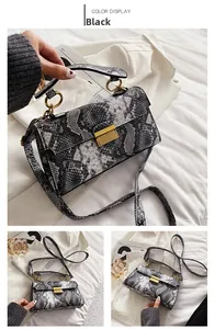 Detailed view of black snake pattern handbag with elegant gold square twist lock