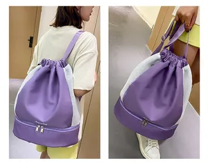 Detail view of purple drawstring backpack showing mesh breathable panel and shoe compartment