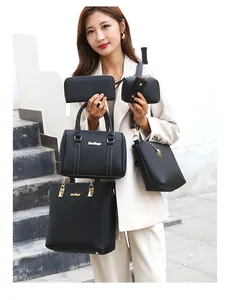 Detailed view of the 5-piece black synthetic leather bag set with lychee texture and gold hardware