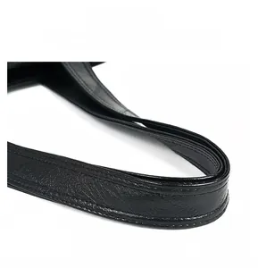 Detail of comfortable black leather handle with reinforced stitching and soft texture