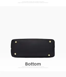 Detail view of the black lychee leather bag bottom with four gold protective metal studs