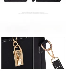 Close-up of golden hardware clasp and white stitching on black pebbled leather tote
