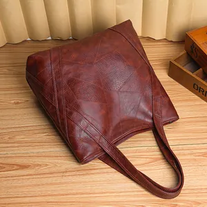 Deep brown washed leather tote bag with geometric stitching and large capacity design