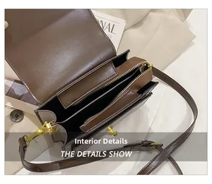 Top view of dark brown leather crossbody bag showing multi-layer interior and gold hardware