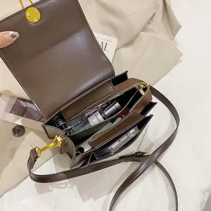 Minimalist dark brown crossbody bag with magnetic closure and organized interior compartments