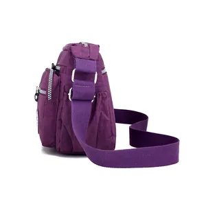 Deep purple casual nylon crossbody bag with multiple zippers and adjustable strap