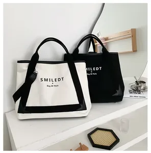 Paire de sacs fourre-tout élégants en toile avec poignées en cuir, noir et blanc