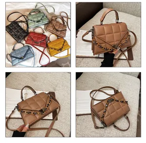 Close-up of quilted pattern details and chain strap on stylish crossbody bag for women