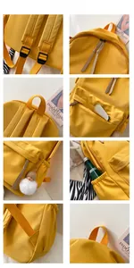 Detail of yellow nylon backpack with padded shoulder straps and cute plush pendant charm