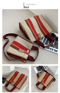 Detail of color-block striped canvas tote bag with gold hardware and leather strap