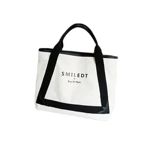 Sac cabas minimaliste en toile crème avec sangle noire et texte SMILEDT imprimé