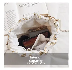 Internal capacity of straw bucket bag showing lace details and spacious storage space