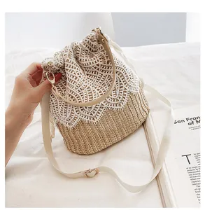 Detail showing natural straw texture with white floral lace trim on a beach bucket bag