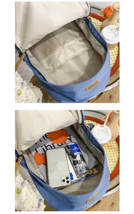 Interior detail of blue nylon backpack showing large capacity with pockets and gadgets