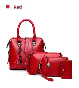 Detail of red 4-piece handbag set featuring tassel cat charm and textured faux leather