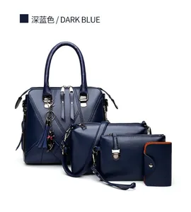 Detail of dark blue four-piece handbag set featuring V-shaped stitching and tassel charm