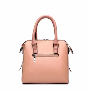 Rear view of pink faux leather handbag showing functional silver zipper pocket and handles