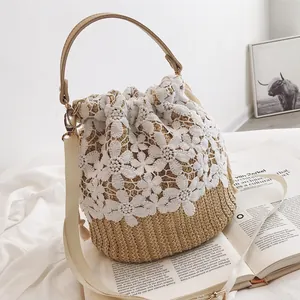 Straw bucket bag with white lace detailing and leather handle for summer beach beach trips